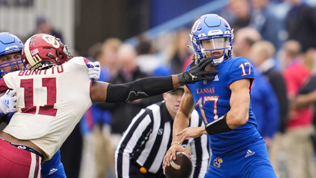 Oct 23, 2021; Lawrence, Kansas, USA; Kansas Jayhawks quarterback Jason Bean (17) drops back to pass as Oklahoma Sooners linebacker Nik Bonitto (11) defends during the second half at David Booth Kansas Memorial Stadium. Mandatory Credit: Jay Biggerstaff-USA TODAY Sports